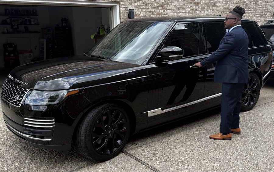 Executive VIP transport — uniformed driver with luxury SUV